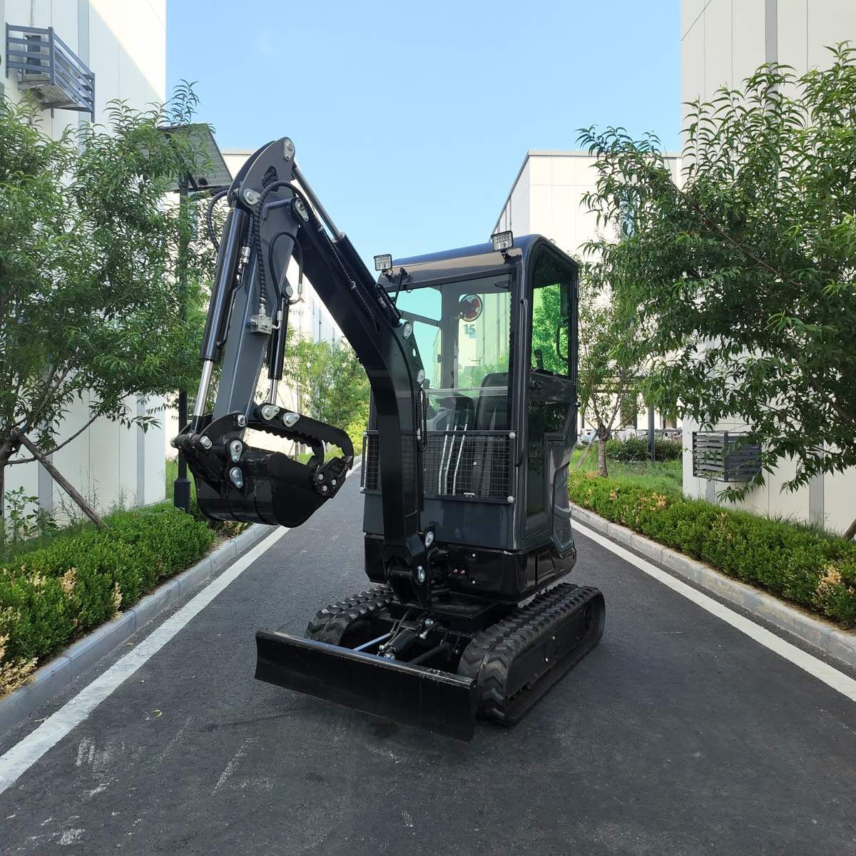 Compact excavator positioned in a narrow landscaped access lane